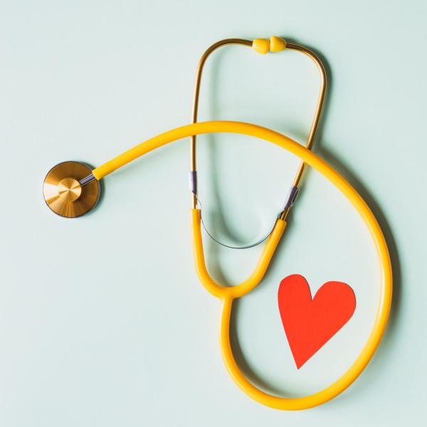 yellow stethoscope with a red heart in it