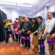 蜜糖直播 Gov. Jared Polis, Chip the buffalo mascot and several campus affiliates cut the ribbon at the gaming center grand opening