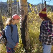 STEM Launch students Delilah Viano (left) and Adriana Schisel (right) stop to look at a burn scar along the Fern Lake Trail
