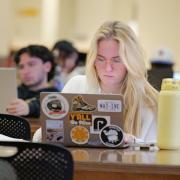 Students working on laptops in Norlin Library