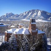 Old Main on a snowy day with Flatirons in the background